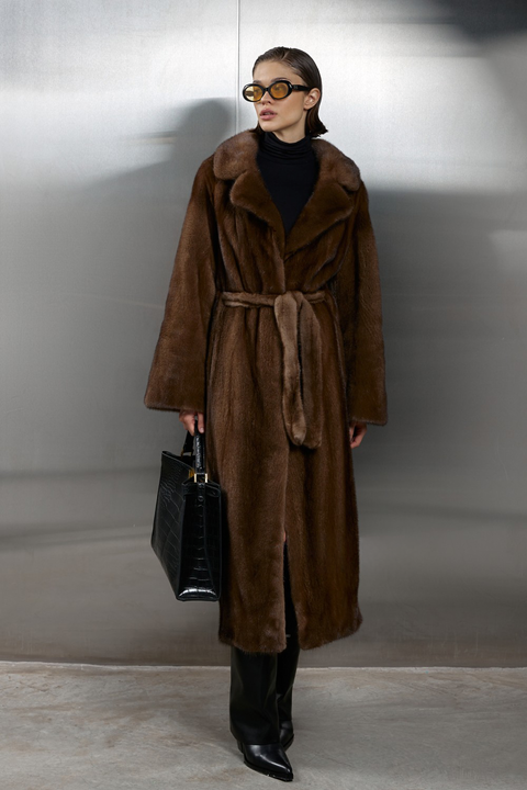 Long genuine brown mink fur coat with a luxurious satin lining, featuring a belted waist and elegant silhouette.