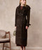 A woman wears the Hatti suede leather trench coat, featuring a tailored double-breasted design that flatters her figure with modern sophistication.