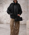 A woman dressed in a high-neck oversized sheepskin jacket with shearling lining, blending comfort with refined style for a sporty, sophisticated appearance.