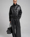 Chic cropped jacket in black genuine leather, perfect for elevated street style and winter layering.