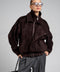 A suede jacket with a high neck and relaxed fit, combining sporty chic style with luxurious texture for effortless everyday elegance.